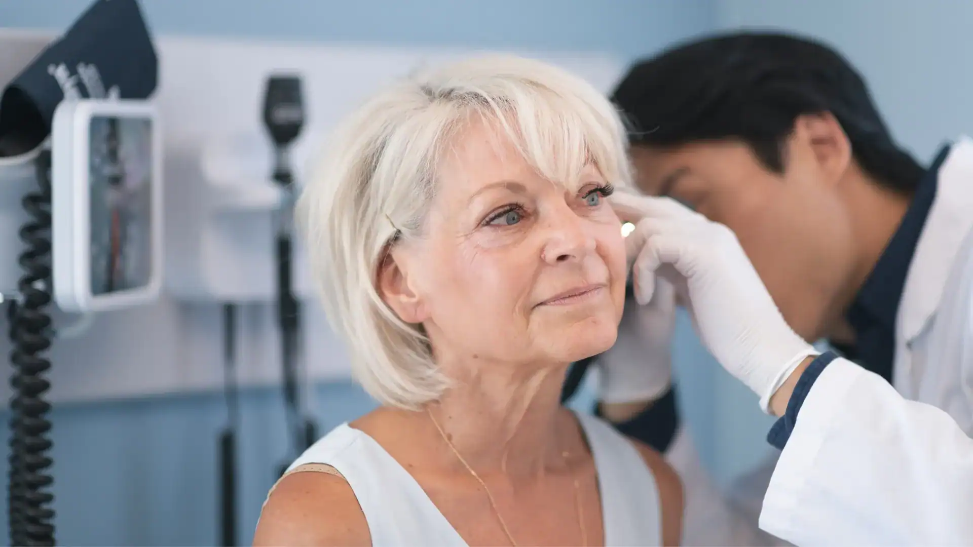 Senior woman undergoing balance test at hearing clinic.
